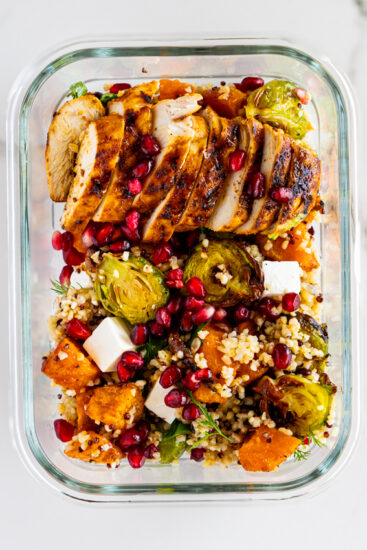 Sweet potato grain salad with chicken in a meal prep container.