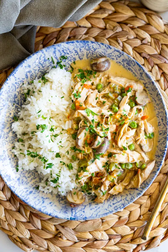 Chicken a la king in serving bowl on dining table.