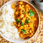 Creamy chickpea butternut squash curry with rice in a serving bowl.