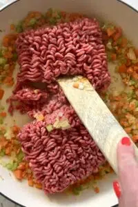 Ground beef browned in pan.