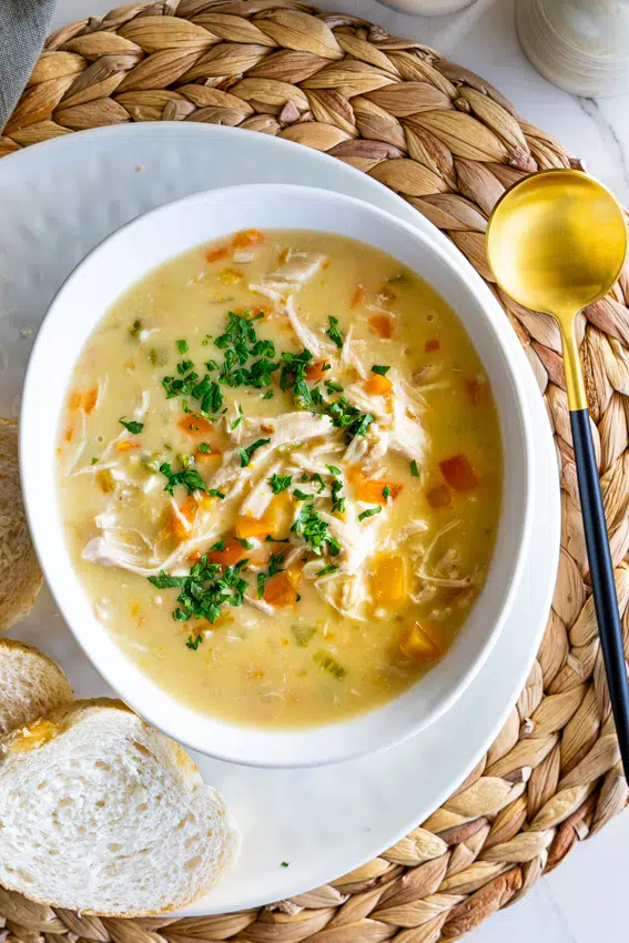 Creamy chicken Soup with fresh bread on dining table,