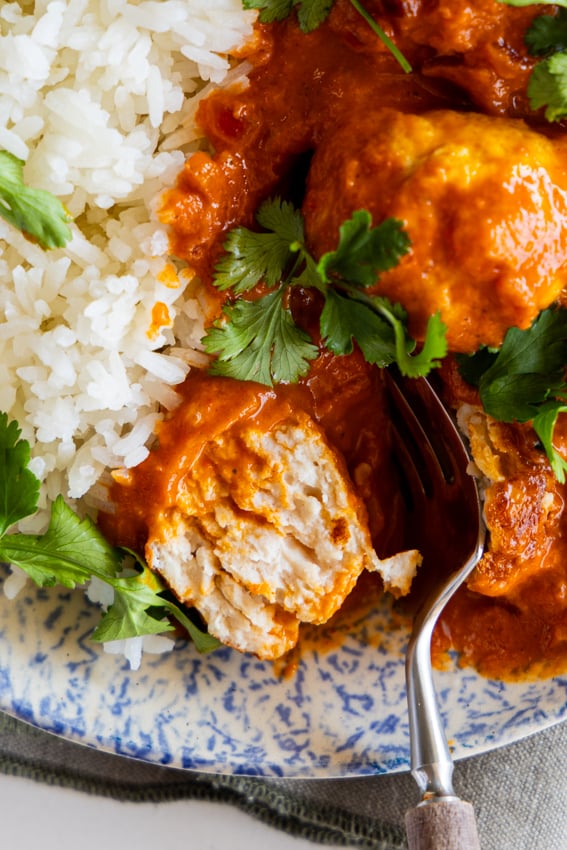 Juicy chicken meatballs in butter chicken curry sauce.