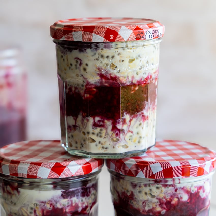 Overnight oats with berry sauce in jars.