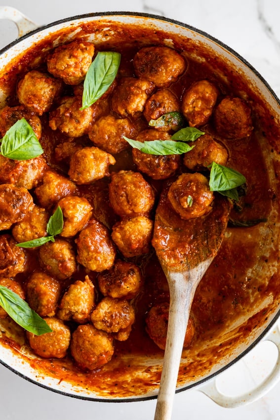 Pork Sausage Meatballs in tomato sauce in skillet.