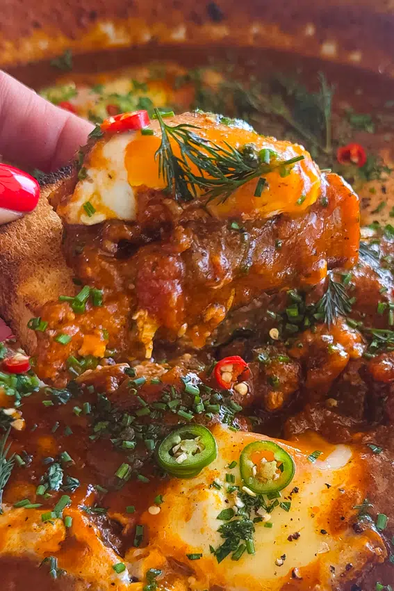 Shakshuka served with crust bread for dipping.