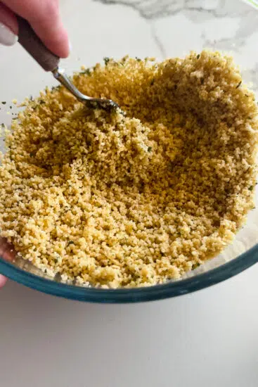 Couscous fluffed with a fork.