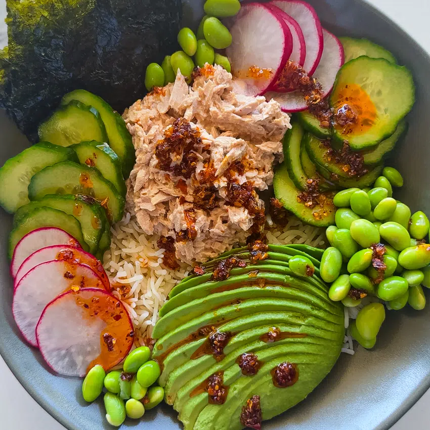 Spicy tuna rice bowl with avocado, cucumber and edamame.