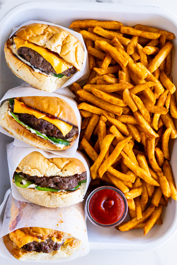 Burgers and fries with ketchup.