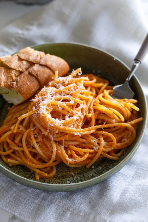 Creamy tomato pasta with garlic bread.