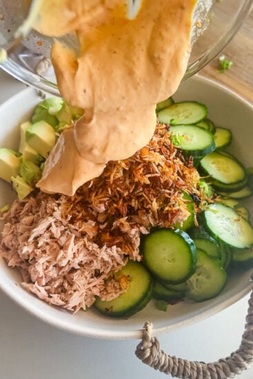 Dressing poured over Easy Spicy Tuna Crispy Rice Salad.