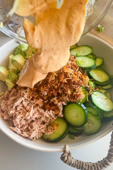 Dressing poured over Easy Spicy Tuna Crispy Rice Salad.