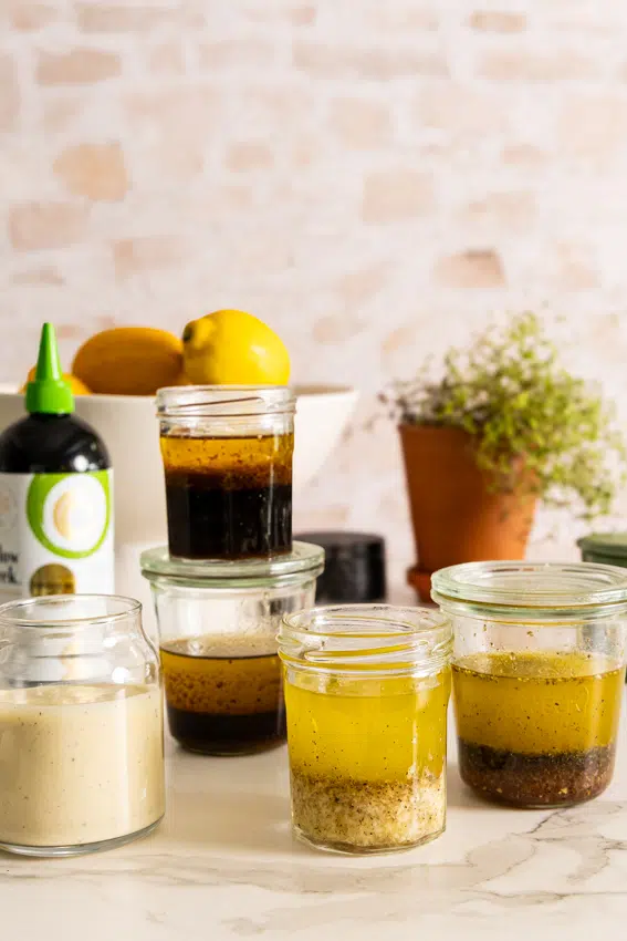 5 Easy Homemade Salad Dressings on a kitchen counter.