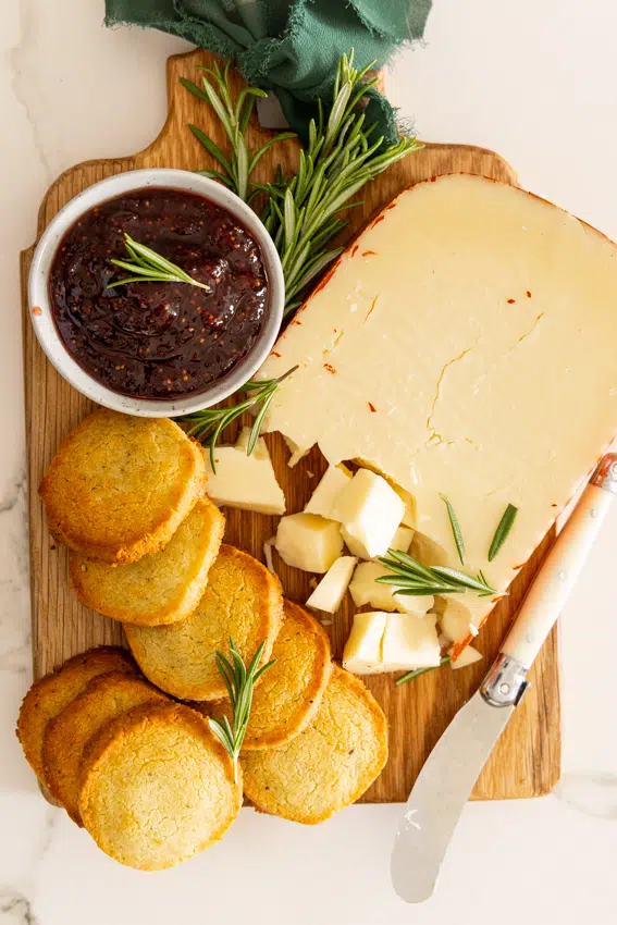 Garlic Parmesan Shortbread Crackers on a cheese board with fig jam.